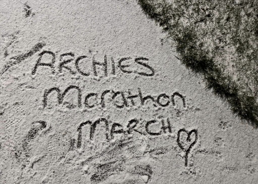 Archies Marathon March with a love heart written in the sand
